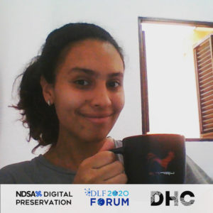 Ana holding a coffee cup and smiling for a Forum photo booth image