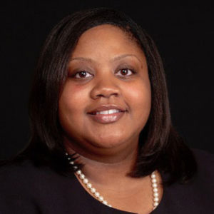 A headshot of Sabrina with a pearl necklace