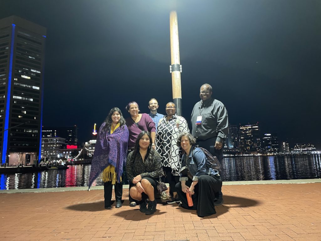 Several 2022 DLF Forum Fellows pose in the Baltimore harbor after a fun night out on the town.